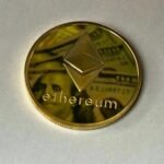 Close-up of a shining Ethereum coin reflecting a dollar bill, symbolizing digital currency and wealth.