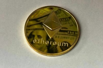 Close-up of a shining Ethereum coin reflecting a dollar bill, symbolizing digital currency and wealth.
