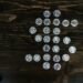 Flat lay of Bitcoin coins arranged in a shape on a wooden surface representing digital currency.
