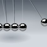 Dynamic illustration of Newton's Cradle showing motion and reflection concepts in physics.